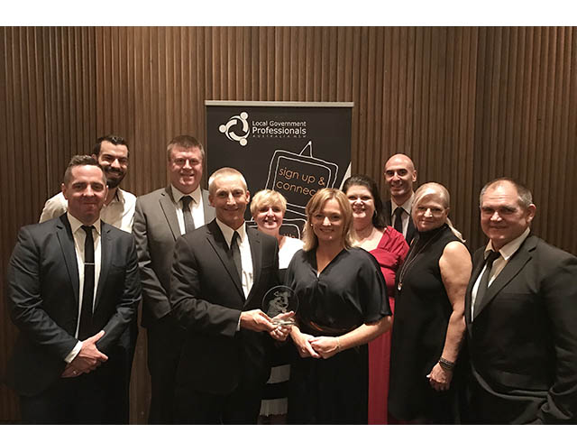 General Manager and team hold the award