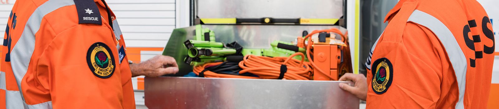 Image of fire fighters making sure their trucks are prepared for an emergency banner image