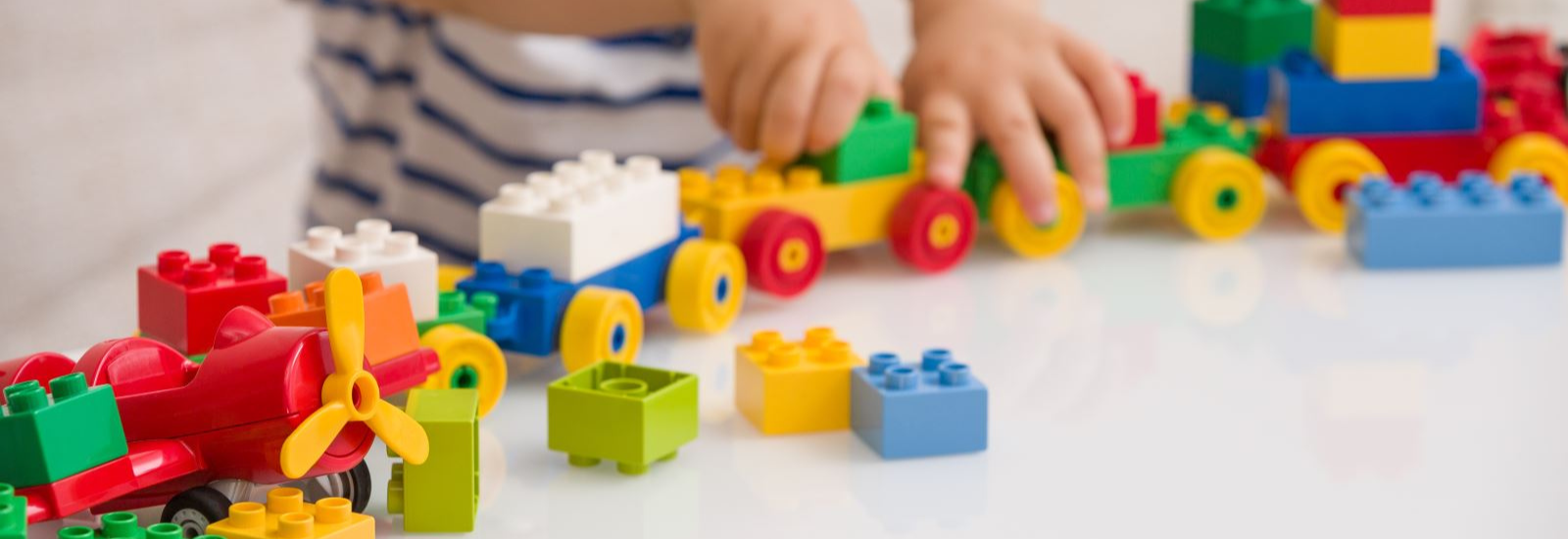 Child playing with lego banner image