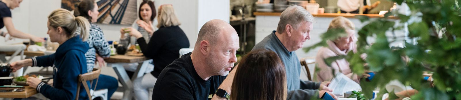 Image of people enjoying themselves in a cafe banner image