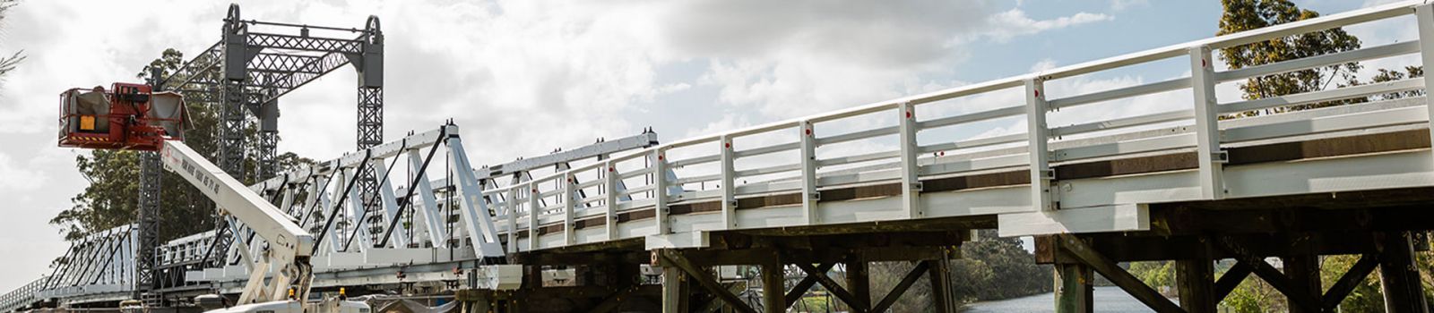 Image of a bridge being worked on by a cherry picker banner image