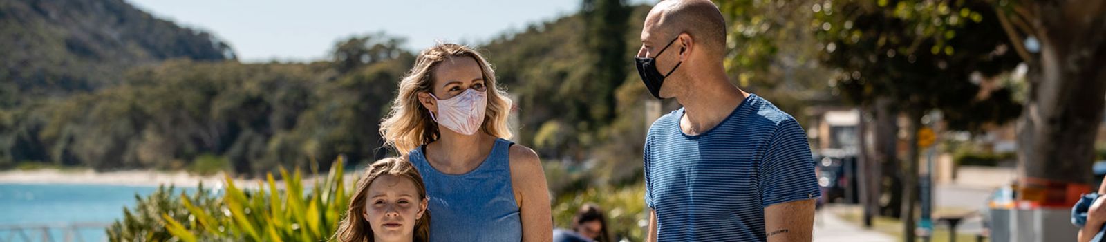 Image of a family in Nelson Bay with both parents wearing a mask banner image