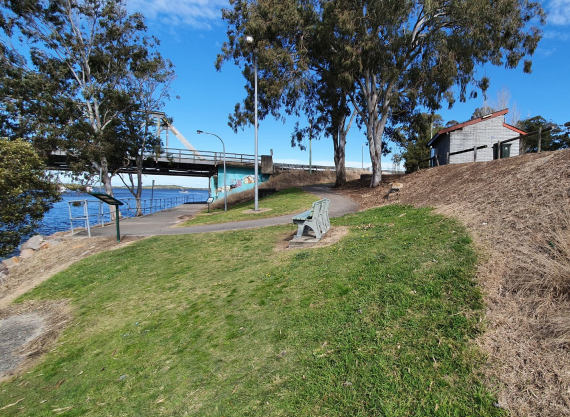 A grass patch with the Karuah bridge in the background