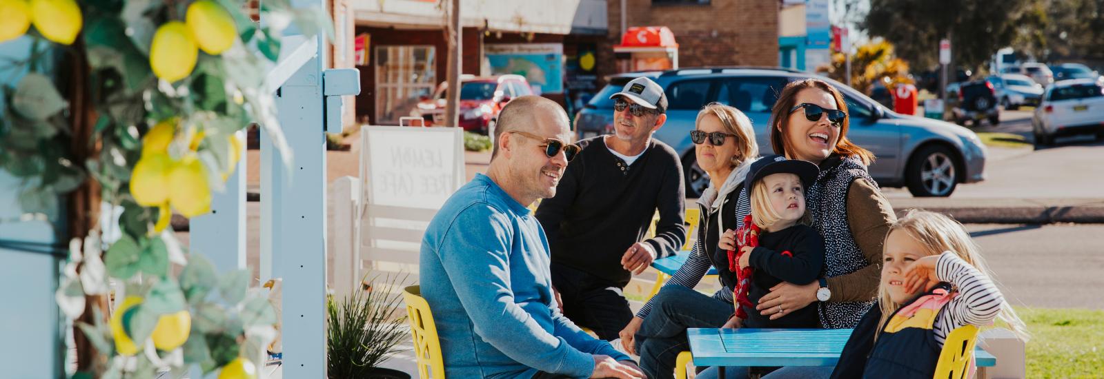 Family sitting at a café in Lemon Tree Passage banner image