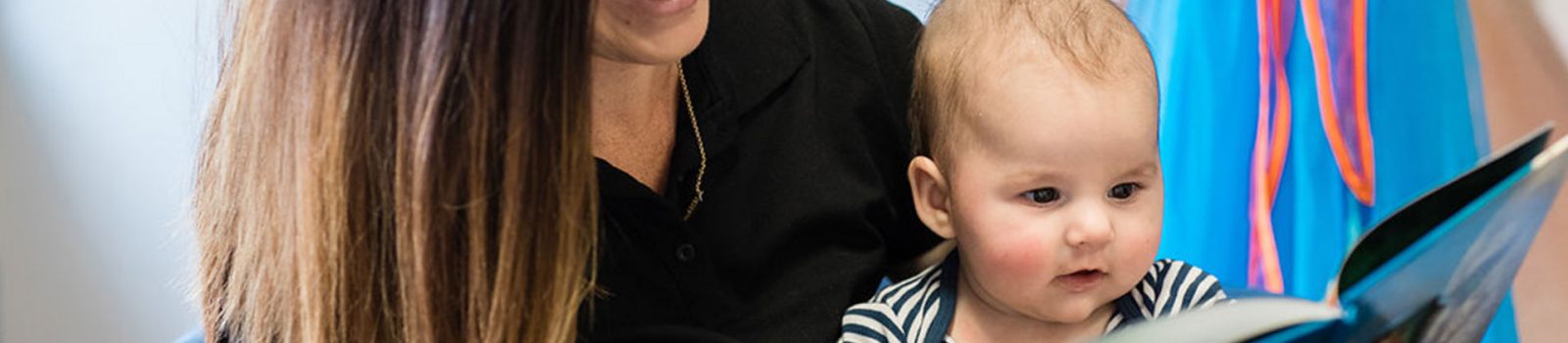 Image of a women and baby reading a book  banner image