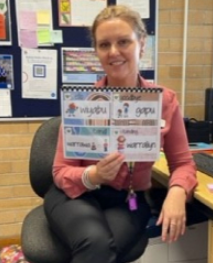 Toni Lyle holding a book about Gathang language