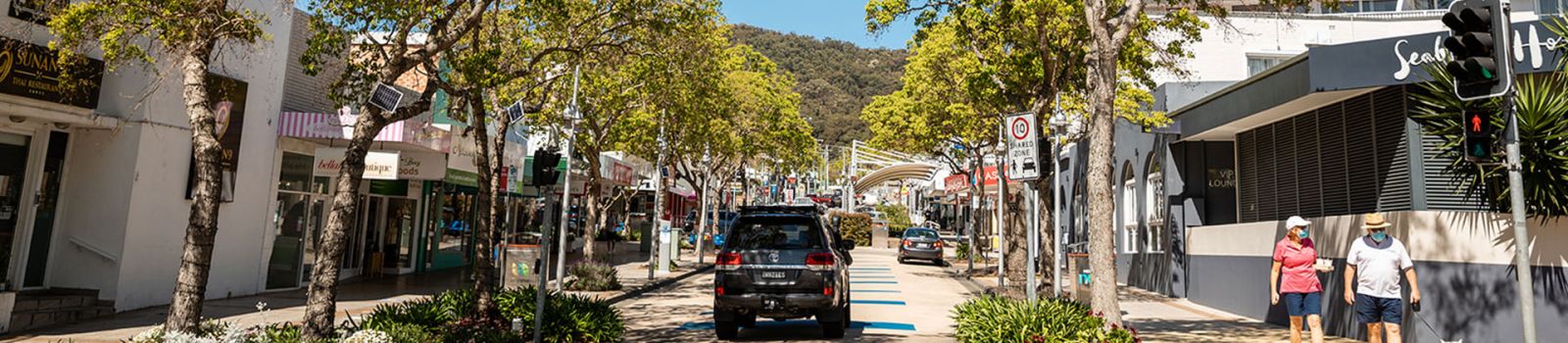 Image looking up the main street of Nelson Bay with all the shops  banner image