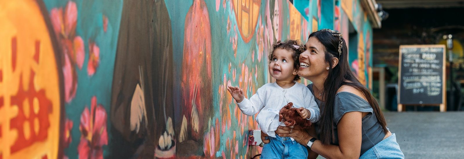 Woman and child looking at a mural  banner image