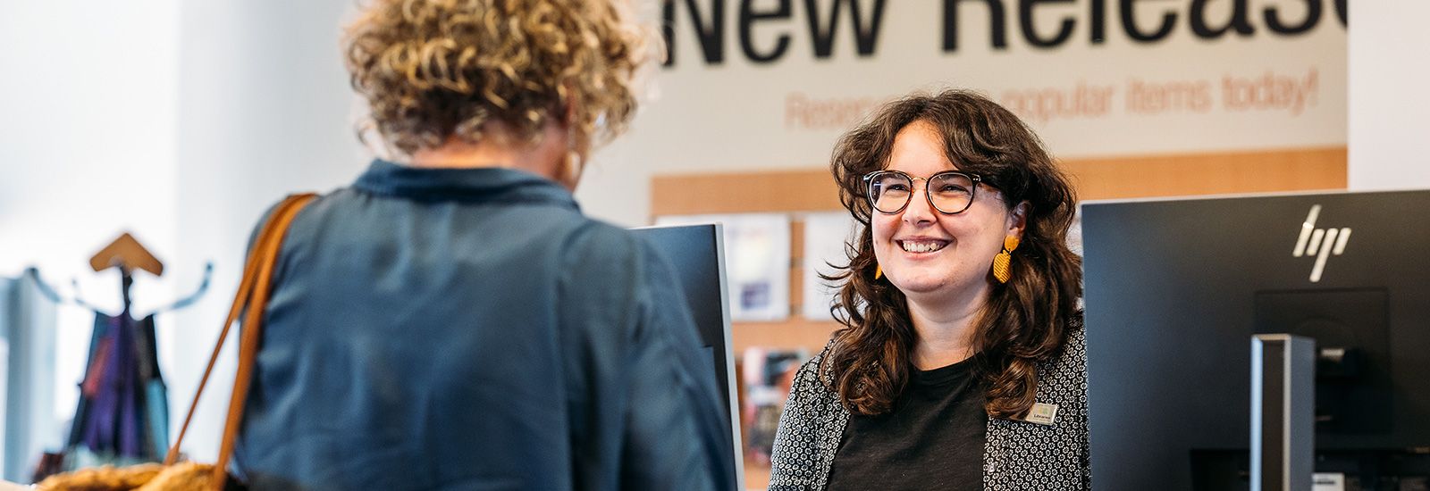 Image of an older woman smiling in the library banner image