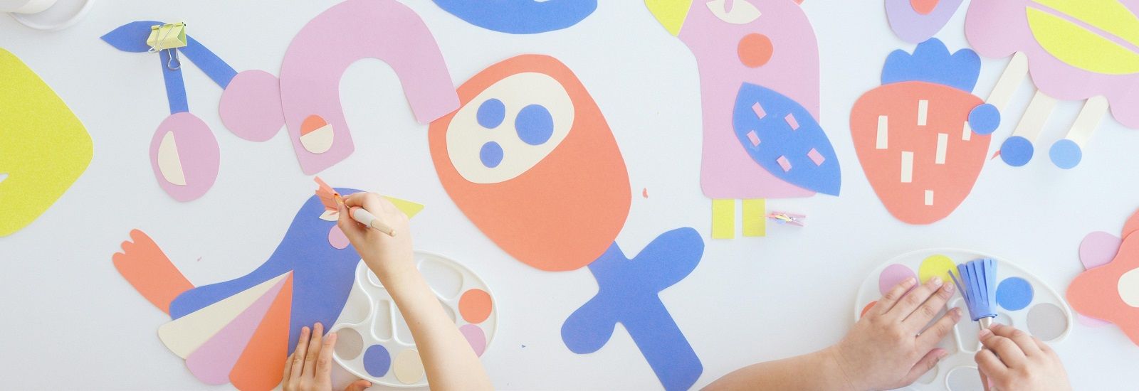 two children completing arts and crafts banner image