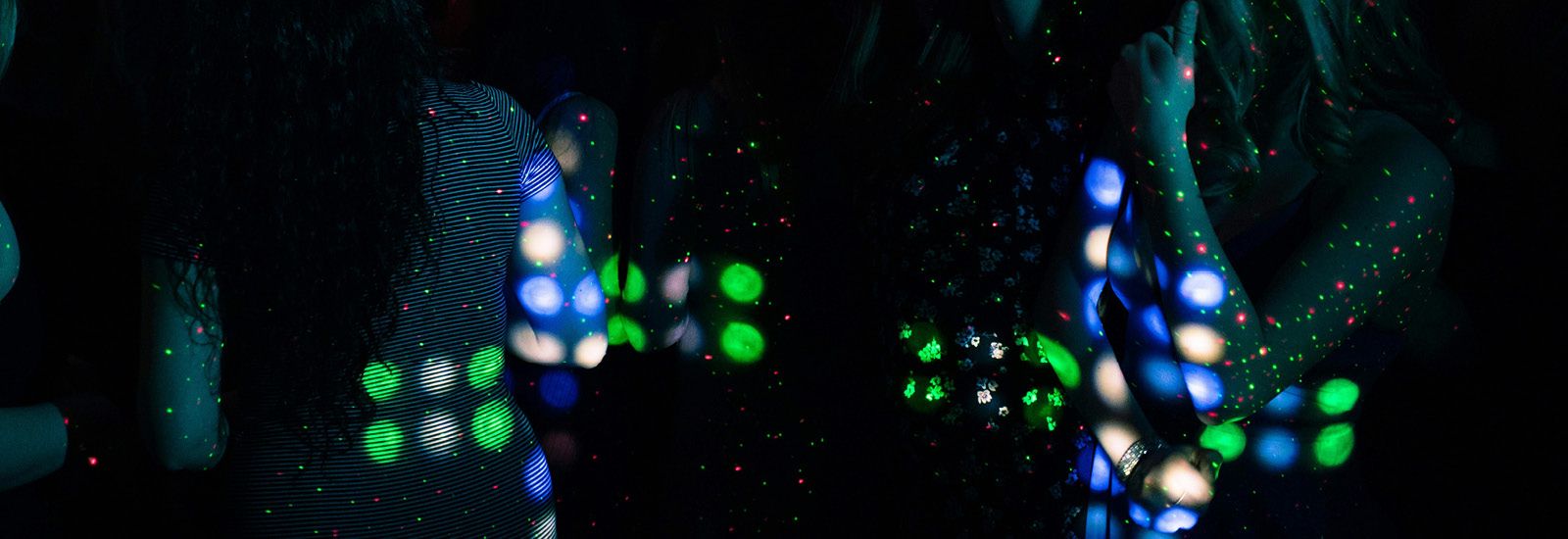 two people standing under disco lights banner image