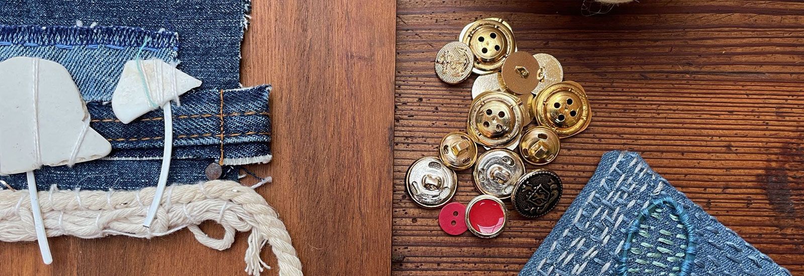 denim and buttons on a table banner image