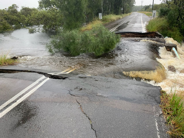 Road washed away by flood water at Foreshore Drive, Corlette