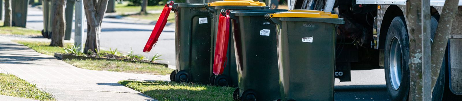 Image of different coloured bins and a garbage truck  banner image