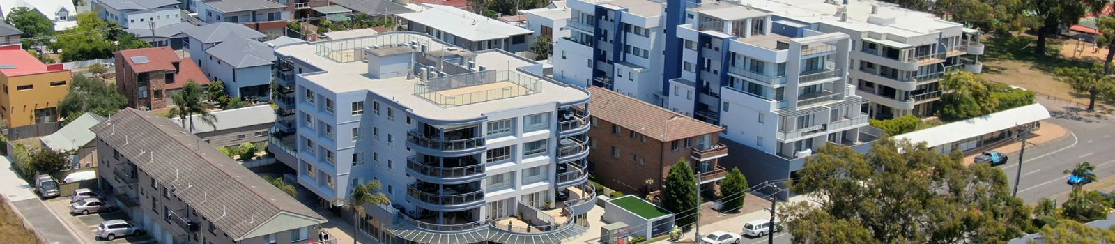 Image of buildings along a foreshore banner image