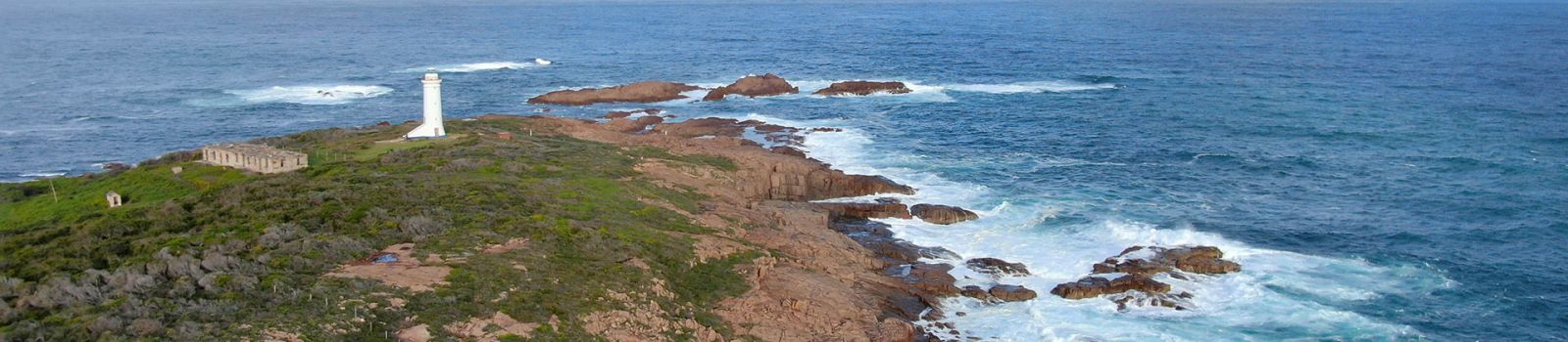 Rough seas around a rocky coastal point  banner image