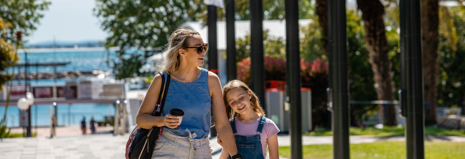 Mum and daughter walking through park in Nelson Bay banner image