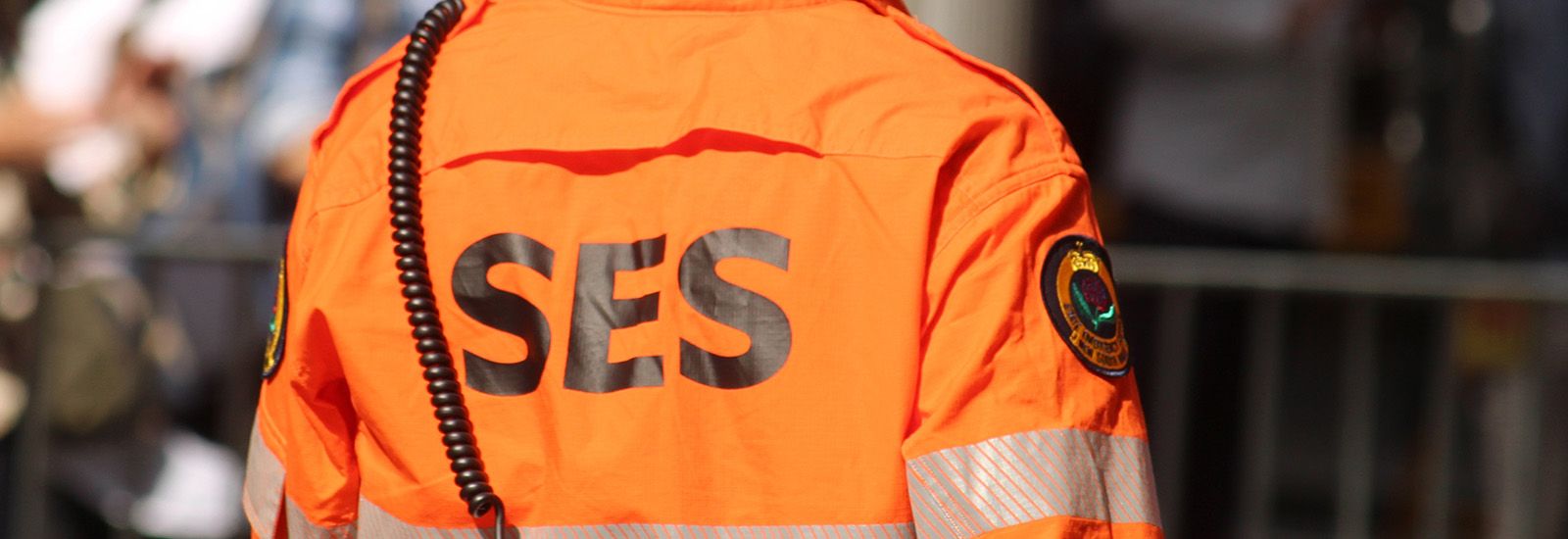 man wearing orange SES shirt banner image