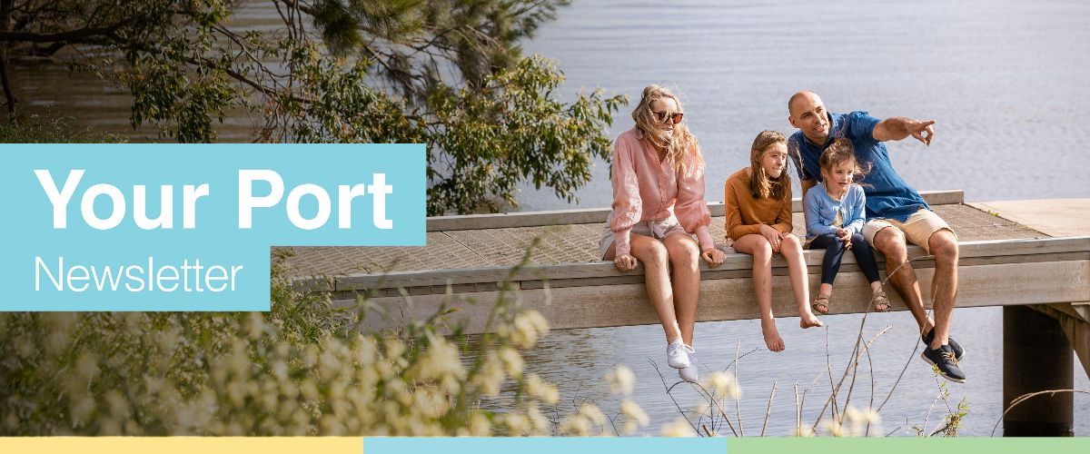 Family sitting on bridge above water