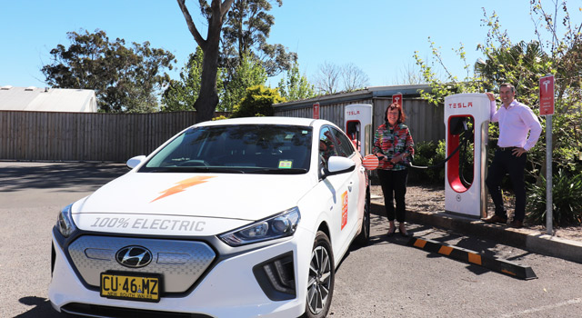 Port Stephens Mayor Ryan Palmer and Lake Macquarie Mayor Kay Fraser charging an electric vehicle at Telsa charging station at Heatherbrae.