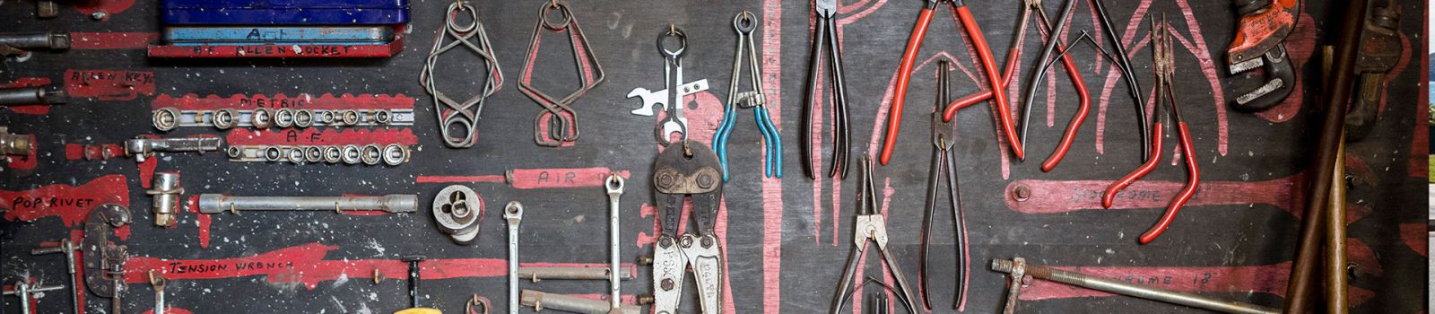 Image of builders board with tools hanging banner image