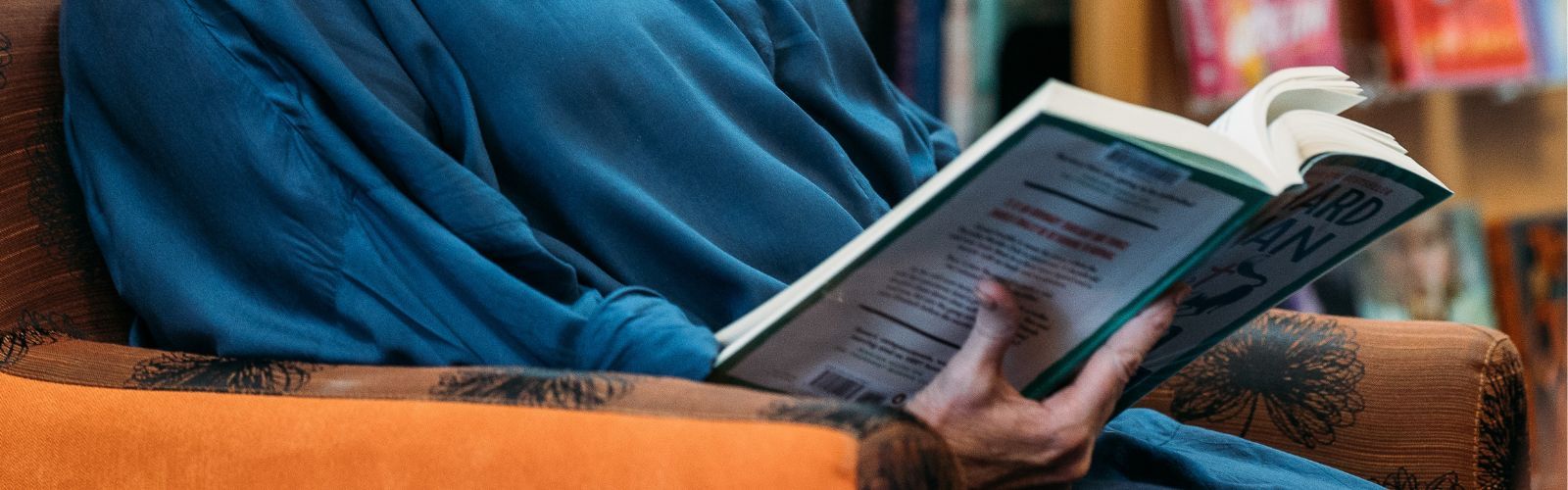 Lady reading book at library banner image